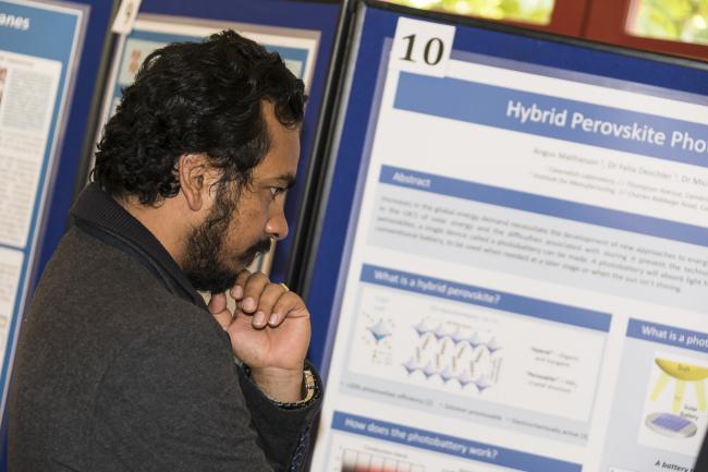 Junior Research Fellow Hirak Patra views the poster presentation