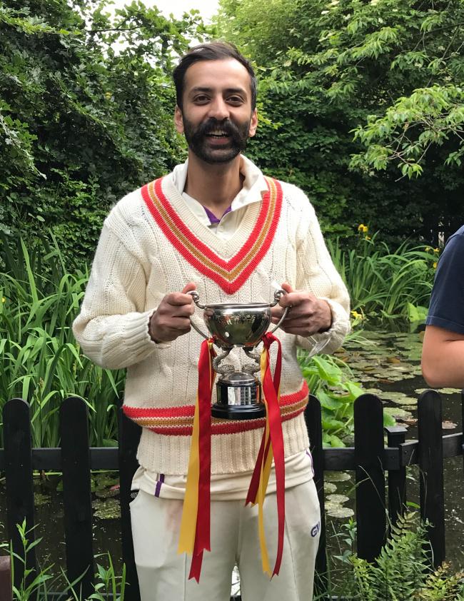 Student Mansoor Sadique with the cup and matching jumper