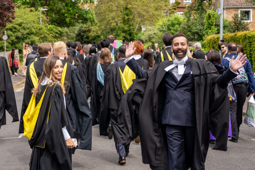 Two students attending the graduation from Wolfson College look at the camera