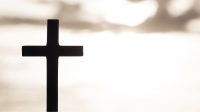 Silhouette of a cross with a soft-focused background.